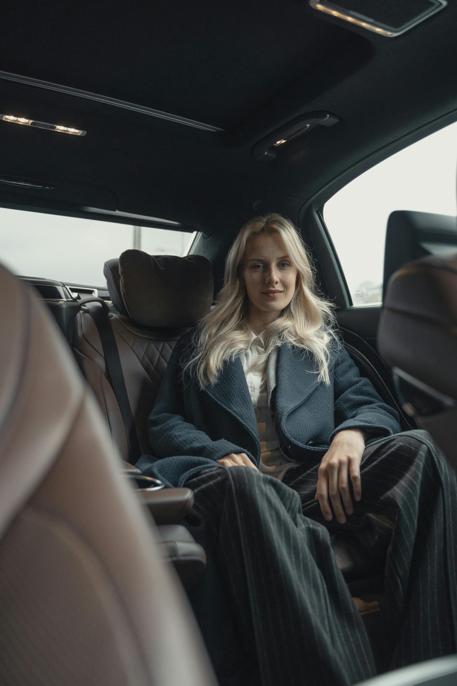 A traveller seated in the back of a private car transfer